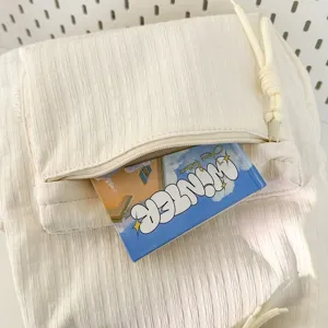 Gros plan sur les détails de la poche avant du sac à dos beige froissé pour l'école.