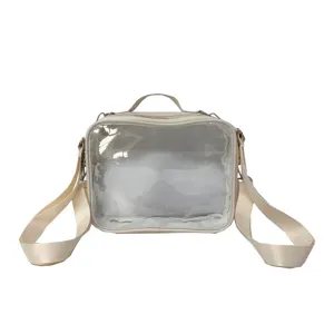 Clear front window crossbody ita bag detail shot, beige material with adjustable strap.