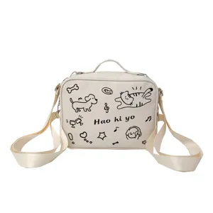 Cute beige canvas shoulder bag with doodle cat and dog print, casual daily student crossbody bag.