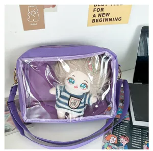 Detailed view of cute purple ita bag with clear window and plush doll inside lifestyle setup.