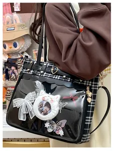 Japanese JK plaid ita bag detail showing transparent PVC window, heart hardware, and charms.