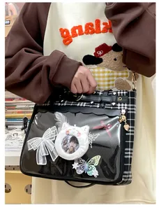 Detailed view of Japanese anime style ita bag with clear PVC pocket and grid pattern.