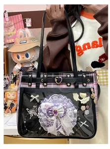 Detail shot of anime Ita bag transparent window with lace bow brooch and plaid fabric
