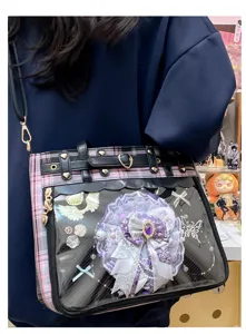Clear PVC window Ita bag detail, pink plaid shoulder bag with purple rosette badge.
