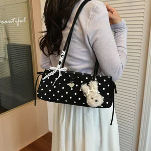 Chic polka dot shoulder bag with cute rabbit pendant, stylish underarm bag for women daily commute.