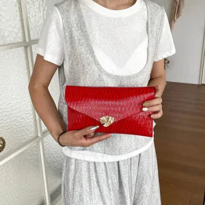 Elegant red envelope clutch bag for women, stylish metal clasp design for evening parties.