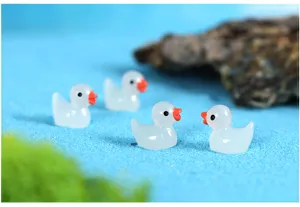 Miniature resin ducks detail shot, luminous micro landscape garden ornament and micro decor.