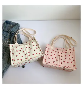 Corduroy strawberry tote bag detail view, casual shoulder bag with double pockets, cute style.