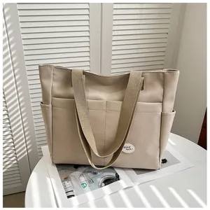 Large capacity canvas tote bag for women, casual work commuting shoulder bag with multiple pockets.