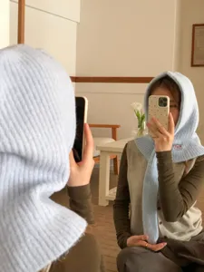 Light blue knitted balaclava hood with integrated scarf for cozy winter daily fashion.