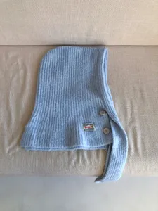 Cozy knit balaclava detail, warm wool blend winter hood scarf with buttons and label.