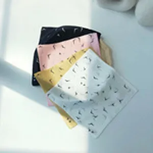 Close-up detail of multi-color printed square scarves, lightweight fabric and fine pattern display.
