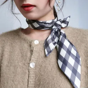 Black and white plaid silk scarf neck ribbon close-up detail showcasing styling option.