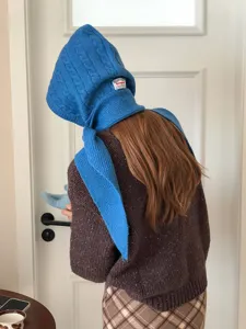 Blue knit balaclava hood scarf detail, cozy winter knitted headwear texture close-up.