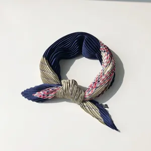 Detailed shot of a Korean-style pleated small square scarf with navy blue and khaki plaid design.