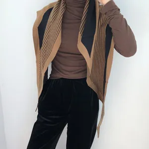 Winter warm knit scarf shawl detail shot, stylish brown and black striped design for women.