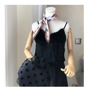 Detailed view of a pleated retro small square silk scarf styled on a mannequin outfit.
