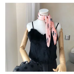 Detail shot of pink pleated retro art print neckerchief scarf styled on mannequin display.