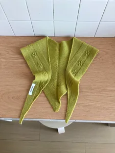 Green knitted wool triangle scarf detail view, cozy winter shawl bib for women and daily wear