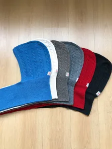 Detailed view of knitted balaclava winter warm cap and scarf set for stylish cold weather.