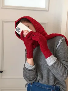 Detailed shot of cozy winter red knit balaclava and matching gloves set, stylish cold weather outfit.
