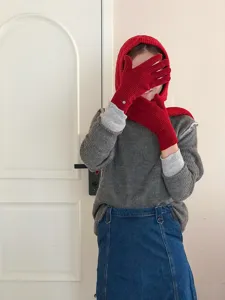 Red knitted balaclava hood scarf set with gloves worn by model, cozy winter fashion outfit detail.