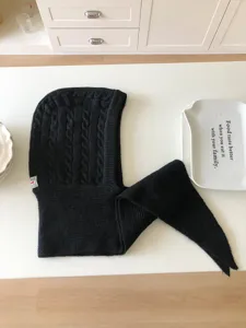 Black knitted balaclava hood scarf detail shot flat lay textured fabric winter fashion