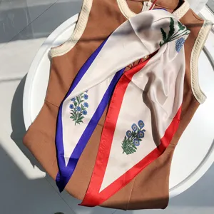 Chic diamond silk scarf with floral print and color block edges, stylish neck accessory.