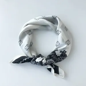 Detailweergave van een zwart-witte zijden sjaal met een prachtig klassiek patroon.