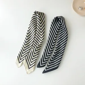 Silk-feel narrow scarf featuring chic black and white chevron stripes, elegant accessory for women.
