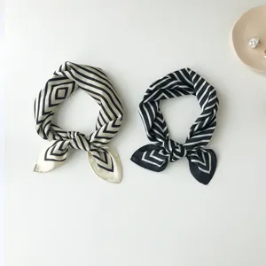 Detailed view of elegant geometric pattern silk scarves, perfect for professional neckwear styling.