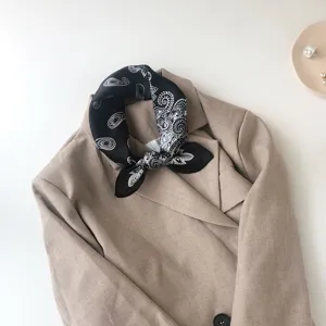 Detailed view of the black and white paisley silk scarf showcasing elegant neckerchief design.