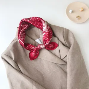 Red printed silk square scarf featuring elegant equestrian motif, perfect for chic styling.