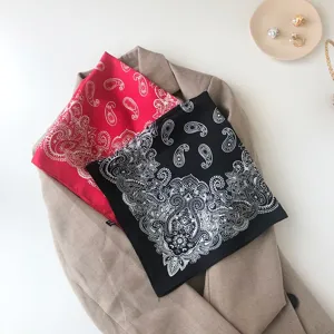 Details of classic paisley print faux silk square scarf, elegant neckerchief style.