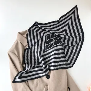 Pleated geometric striped small square scarf detail view, elegant black and white design.
