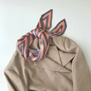 Pleated geometric striped small square scarf neckerchief elegantly styled over a chic blazer.