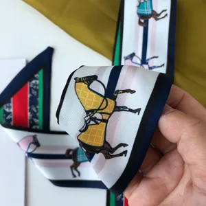 Gedetailleerd overzicht van de smalle zijden sjaal met paardenprint voor nek en tas.