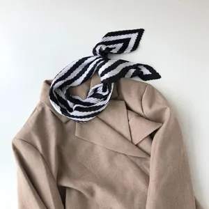 Black and white geometric pleated neckerchief, stylish scarf detail display for women.