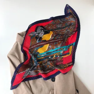 Detailed view of the pleated printed square scarf with geometric stripe and polka dot patterns.