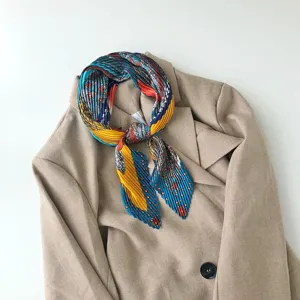 Pleated printed square scarf with geometric stripe and polka dot patterns, elegant neckerchief style detail.