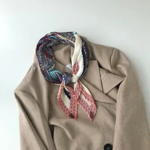 Elegant pleated silk scarf featuring a colorful geometric polka dot pattern for women.
