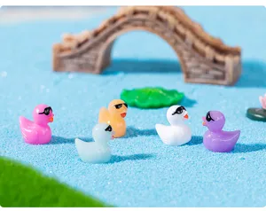 Détail de scène de canards en résine, figurines de canard colorées pour décor de mousse.