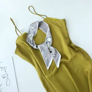 Chique smalle zijden sjaal met abstract paardenpatroon, elegante halslint en tasaccessoire.