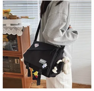 Detail shot of Japanese harajuku style canvas messenger bag, large capacity, student style.