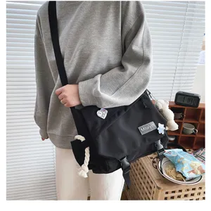 Japanese Harajuku casual black messenger bag, large capacity student crossbody bag detail.