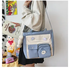 Canvas crossbody bag for students, aesthetic multi-pocket shoulder bag with blue and white design.