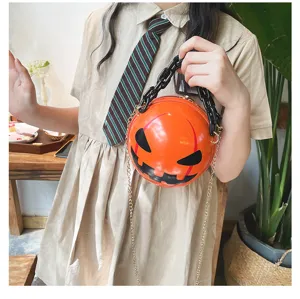 Detailed view of Halloween pumpkin round handbag, glossy orange purse with chunky chain.