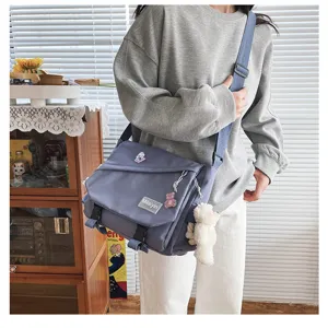 Detail view of the casual canvas messenger bag showing shoulder strap and large capacity.