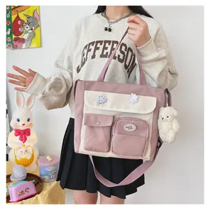 Korean style canvas crossbody bag with multiple pockets and cute bear pendant for daily use.
