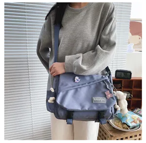 Detail shot of the casual grey-blue canvas messenger bag with large capacity and pins.